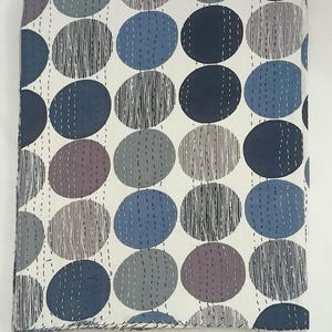 May include: A rectangular textile featuring a repeating pattern of large circles in shades of navy blue, slate grey, and charcoal. The circles are filled with vertical white dashed lines and fine black line textures, all set against a cream background.