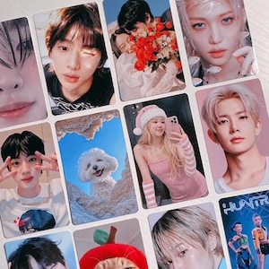 May include: A collection of rectangular photo cards featuring various images. The cards display portraits of people, a cat wearing a red hat, a dog, and a couple. The color palette includes pink, blue, and neutral tones.