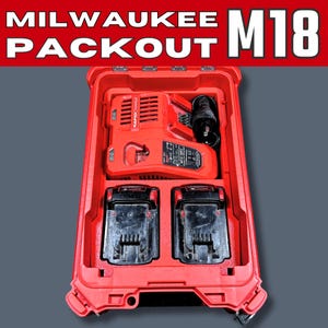 May include: Red Milwaukee Packout storage case with the text "MILWAUKEE PACKOUT M18" at the top. Inside the case are a red rapid charger, two black batteries, and a black power adapter. The case is open, revealing the contents.