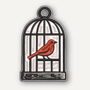 May include: An embroidered patch featuring a red bird inside a black and white birdcage. The design includes a circular loop at the top for hanging or attachment, with detailed stitching outlining the cage bars and the bird's form.