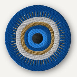 May include: A circular embroidered patch featuring a stylized eye design. The center is a solid black circle surrounded by concentric rings of light blue, gold, and white. The outer edge is a deep blue with radiating gold lines.