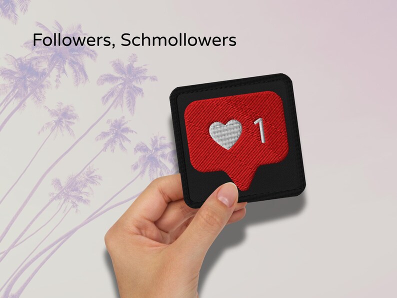 Flat lay of Micro Influencer patch iron-on with red Instagram heart icon, 1 Like text, on neutral background, showing crisp embroidery and playful self-deprecating humor, perfect for jackets, backpacks, or gifts.