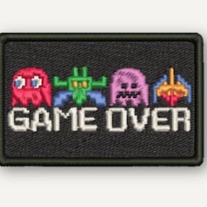 May include: A rectangular embroidered patch with a black background featuring four colorful pixelated video game characters in a row above the white text GAME OVER. The patch has a thick black stitched border and a textured fabric surface.