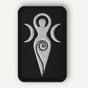 May include: Embroidered black patch featuring a white Triple Goddess symbol. The design includes a central figure with a spiral and crescent moons on either side. The patch has a rectangular shape with rounded corners.