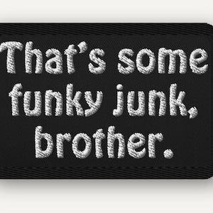 May include: A black embroidered patch with the phrase "That's some funky junk, brother." in white thread. The patch has a rectangular shape with rounded corners and a black border.