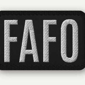 May include: A rectangular embroidered patch with a black background and a thick black border. The text FAFO is stitched in bold, white, capital letters across the center of the patch, featuring a clear, sans-serif font style throughout.