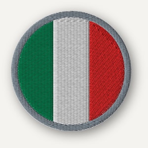 May include: A circular embroidered patch featuring the Italian flag with vertical stripes of green, white, and red. The design is enclosed by a thick, textured grey border, showcasing detailed stitching throughout the entire circular emblem.