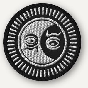 May include: Embroidered patch featuring a yin-yang design with a stylized sun and moon. The patch is round, with a black border and a white and black central design. The sun and moon have detailed eye features. The patch is likely for clothing or accessories.