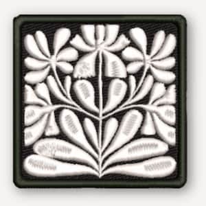 May include: A square embroidered patch featuring a symmetrical white floral design on a black background. The pattern consists of stylized leaves and blossoms arranged in a vertical, branching structure with a dark border framing the square shape.