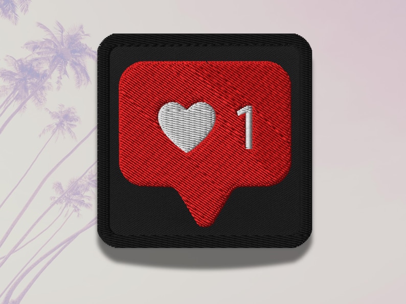 Flat lay of Micro Influencer patch iron-on with red Instagram heart icon, 1 Like text, on neutral background, showing crisp embroidery and playful self-deprecating humor, perfect for jackets, backpacks, or gifts.