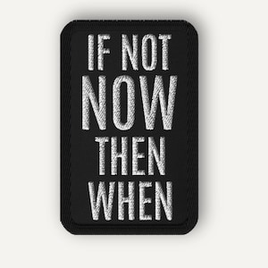 May include: A rectangular black embroidered patch with rounded corners featuring the white stitched text IF NOT NOW THEN WHEN in a bold sans-serif font. The patch has a thick black border and a textured surface created by the embroidery thread.