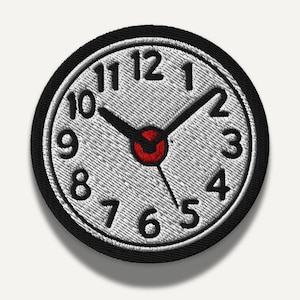May include: Embroidered patch featuring a clock face with black numerals on a light gray background. The clock hands are black, and the center is red. The patch has a black border.