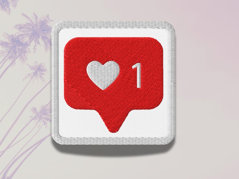 Flat lay of Micro Influencer patch iron-on with red Instagram heart icon, 1 Like text, on neutral background, showing crisp embroidery and playful self-deprecating humor, perfect for jackets, backpacks, or gifts.