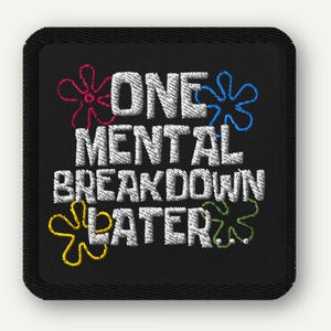 May include: Black square patch with white embroidered text: "ONE MENTAL BREAKDOWN LATER." The text is surrounded by colorful embroidered flowers in pink, blue, yellow, and green. The patch has a black border.
