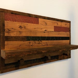 reclaimed wood wall shelf with railroad spike coat hooks