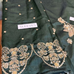 Front view of green Pakistani bridal embroidered sharara dress with gold detailing – perfect for Nikkah and wedding events