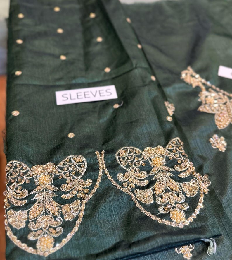 Front view of green Pakistani bridal embroidered sharara dress with gold detailing – perfect for Nikkah and wedding events
