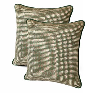 May include: Two decorative throw pillows with a green and white dot pattern. The pillows have a green border and are rectangular and square shaped. The pillows are on a white background.