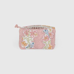 May include: A pink floral patterned zippered pouch with a bird and flower design. The pouch features a repeating pattern of pink flowers, green leaves, and blue birds. The zipper pull is a small fabric loop.