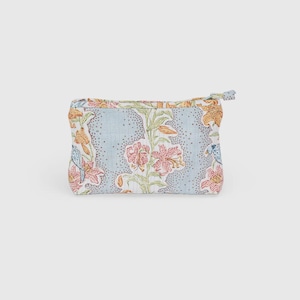May include: A small, rectangular floral print pouch with a zipper closure. The pouch features a light blue background with a pattern of pink, orange, and blue flowers and leaves. The zipper pull is a small fabric loop.