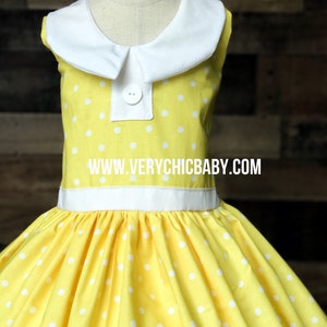 May include: A yellow sleeveless dress with white polka dots and a white Peter Pan collar. The dress has a white sash around the waist and a button closure at the neckline. The dress is made of a soft, comfortable fabric and is perfect for a special occasion. www.verychicbaby.com