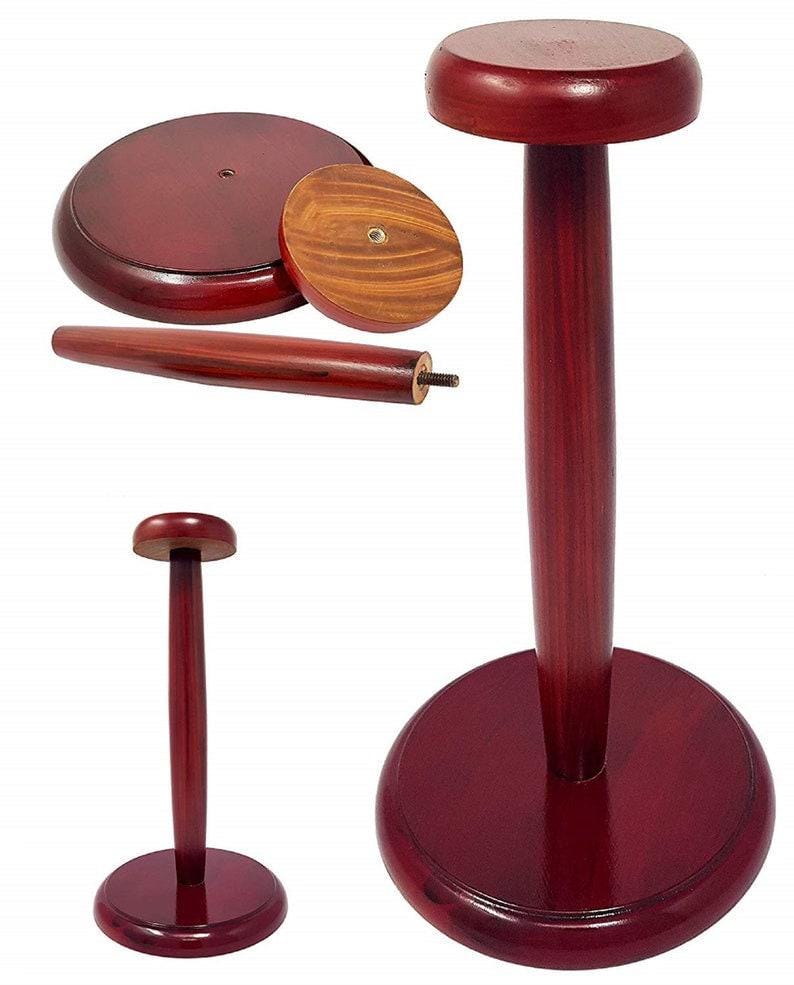 May include: A wooden hat stand with a round base and a tall, slender post. The stand is made of dark red wood and has a smooth finish.