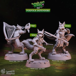 May include: Three 3D printed miniature figurines of fox-like creatures, each with a different class: Bard, Rogue, and Paladin. The figures are painted in a light gray color and stand on circular bases. The text "Woodland Heroes 968 Foxfolk Defenders" is at the top of the image.