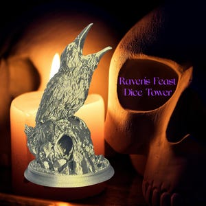 May include: A silver-colored raven statue perched on a rocky base, with its beak open. The statue is in front of a lit candle and a skull. The text "Raven's Feast Dice Tower" is visible in purple.
