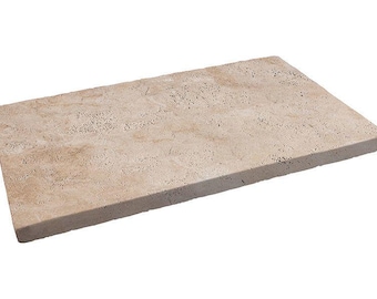May include: A rectangular, beige-colored stone slab with a textured surface. The stone has a natural, porous appearance and is likely made of travertine or a similar material. The edges are slightly rounded.