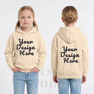 May include: A beige hooded sweatshirt with the text "Your Design Here" in black script on the front and back. The sweatshirt is worn by a child wearing blue jeans.