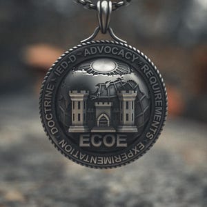 May include: A silver-colored pendant necklace with a detailed circular charm. The charm features a castle design with the text "ECOE" and surrounding text including "IED-D ADVOCACY REQUIREMENTS EXPERIMENTATION DOCTRINE". The chain is also silver.