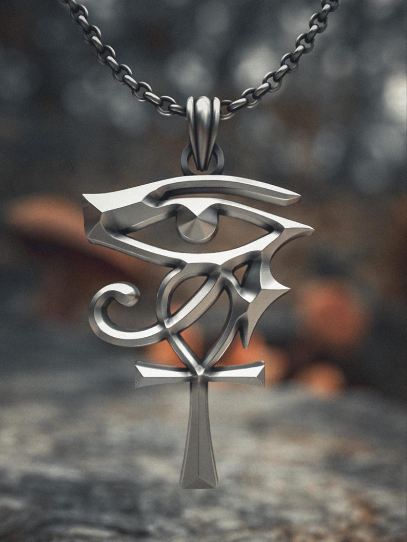Front view of handmade sterling silver Egyptian Ankh pendant displaying the iconic Wadjet eye integrated with the symbol of eternal life.