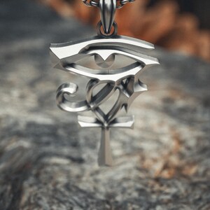 Handcrafted 925 sterling silver Eye of Horus pendant featuring sleek modern design with Ankh symbol on sturdy oxidized chain necklace.