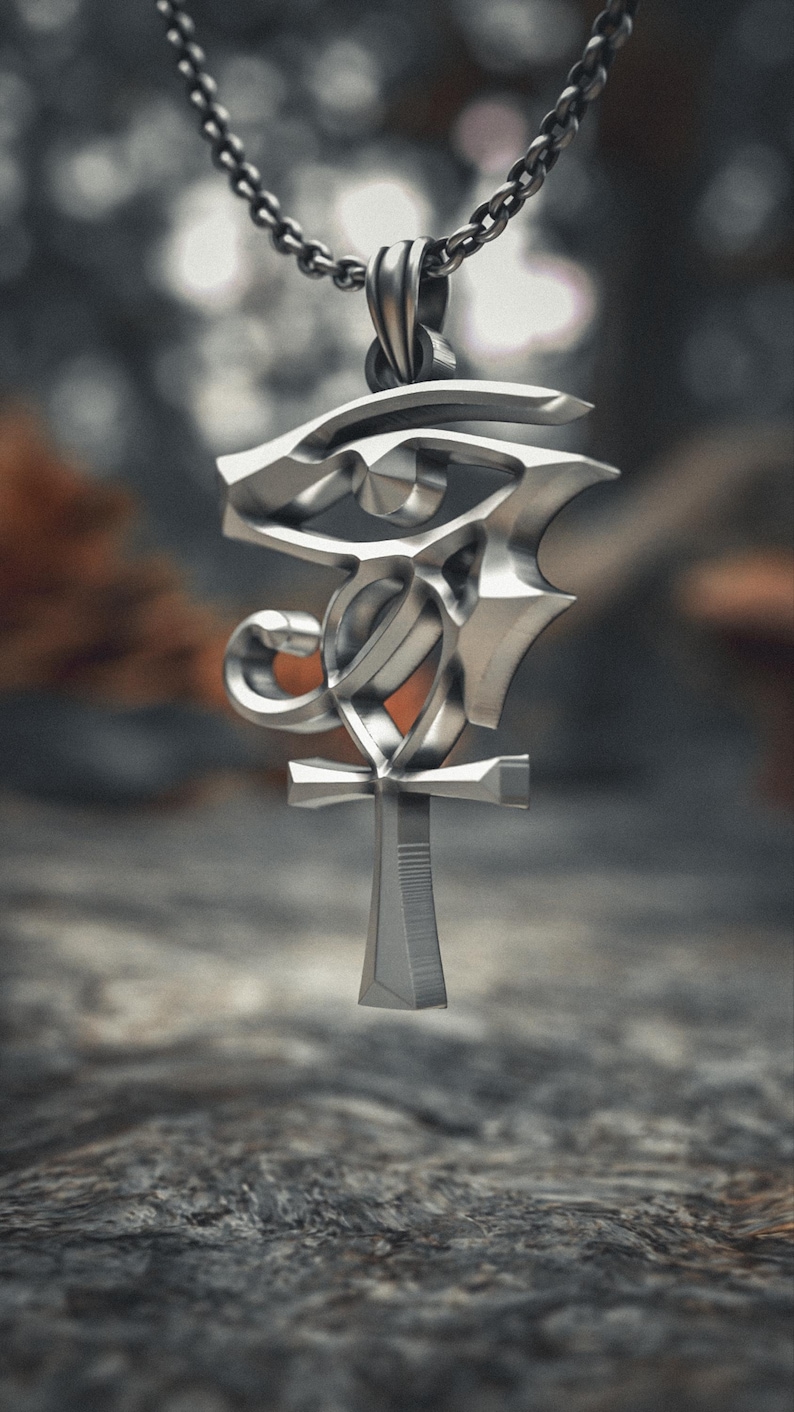 Side angle view of sterling silver Egyptian pendant showcasing the three-dimensional craftsmanship with polished surfaces of the Wadjet eye and Ankh.