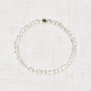 May include: A clear quartz crystal beaded bracelet with a silver bead accent.