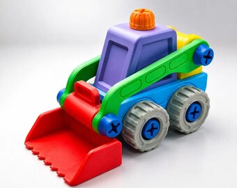 May include: A colorful plastic toy construction vehicle featuring a red front bucket, a purple cab with an orange top knob, green support arms, and blue chassis. The vehicle has four grey wheels with blue cross-head screw centers for assembly.
