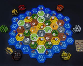 May include: A board game set featuring a hexagonal modular board with terrain tiles representing forests, hills, mountains, fields, and pastures. Includes colored player pieces, resource cards, and a building costs reference card.