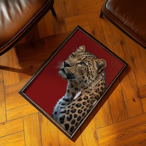 Chic leopard wall art with a bold red background, blending elegance and power. Ideal for retro-inspired or luxury interiors. Digital download product.