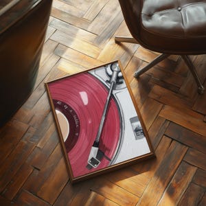 May include: A framed artwork depicting a vintage record player with a red vinyl record. The artwork features the text "All of a Sudden" and is set against a white background. The frame is a warm brown color.