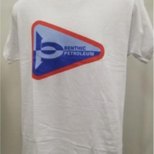 May include: White t-shirt featuring a triangular logo with the text "BENTHIC PETROLEUM". The logo is a combination of blue, red, and white colors. The t-shirt is displayed on a mannequin.