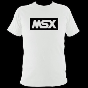 May include: White t-shirt featuring the black letters "MSX" within a black rectangle. The tee has a crew neck and short sleeves. The graphic is positioned centrally on the chest.