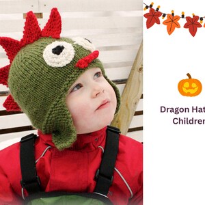 May include: A green knitted dragon hat with red spikes, white eyes, and a red nose. The hat is designed for children and is worn by a child in a red jacket. The image also includes text that says "Dragon Hat for Children".