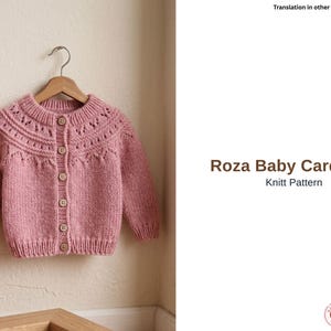 May include: A pink knitted baby cardigan with a round neckline and button closure, hanging on a wooden hanger. The cardigan features decorative knit detailing around the neckline and button band. The text "Roza Baby Cardigan" and "Knitt Pattern" are visible.