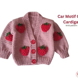 May include: A light pink knitted cardigan with red strawberry appliqués and green leaves. The cardigan has a V-neck, red buttons, and ribbed cuffs. Text on the image reads "Car Motif Crop Cardigan knitt pattern."