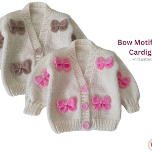May include: Two cream-coloured, knitted cardigans with bow motifs. One cardigan has pink bows, the other has brown bows. The cardigans have a V-neck and button closure. The text "Bow Motif Crop Cardigan" is visible.