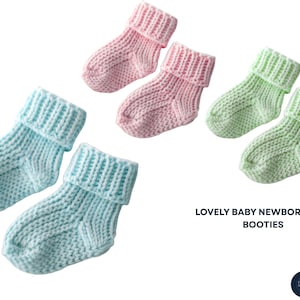 May include: Six pairs of knitted baby booties in pastel colors: pink, light blue, and green. The booties have a rolled cuff design. The text "LOVELY BABY NEWBORN GIFT BOOTIES" is visible.