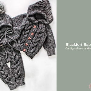 May include: A grey knitted baby set, comprising a hat with pom-poms, a hooded cardigan with heart-shaped buttons, trousers, and a neck warmer. The set is displayed on a white surface. Text on the right reads "Blackfort Baby Set Cardigan-Pants and NeckCap."