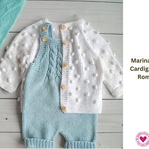 May include: A knitted baby outfit, including a white cardigan with bobble details and a light blue romper. The romper features a cable knit design on the bib. The outfit is displayed on a light wood surface. Text on the image reads "Marina Baby Cardigan and Romper."
