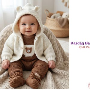 May include: A baby in a cream knitted hooded jacket with bear ears, a brown knitted romper, and matching booties. The jacket has button closures and a bear applique. The text "Kazdag Baby Set Knitt Pattern" is visible.
