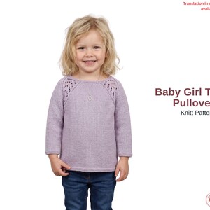 Può includere: Una bambina indossa una tunica lavorata a maglia lilla chiaro con scollo tondo e maniche lunghe. La tunica presenta trafori decorativi sulle spalle. Il testo "Baby Girl Tunic Pullover Knit Pattern" è visualizzato sul lato destro dell'immagine.